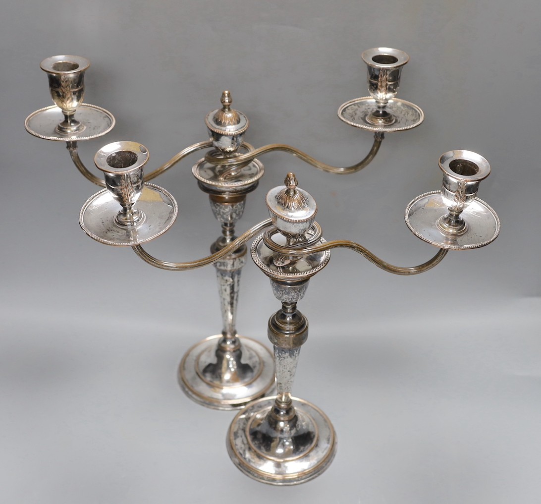 A pair of Sheffield plate two branch two light candelabrum, 37 cms high.